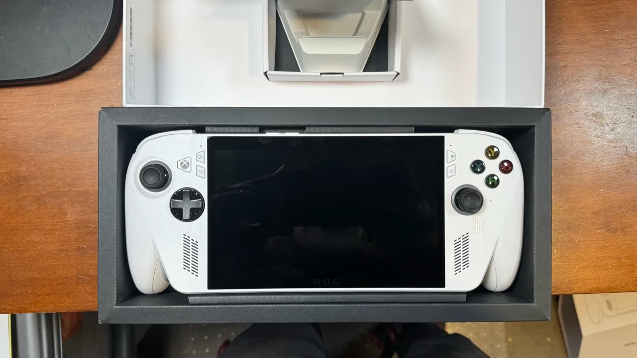 White handheld gaming computer resting in its open packaging.